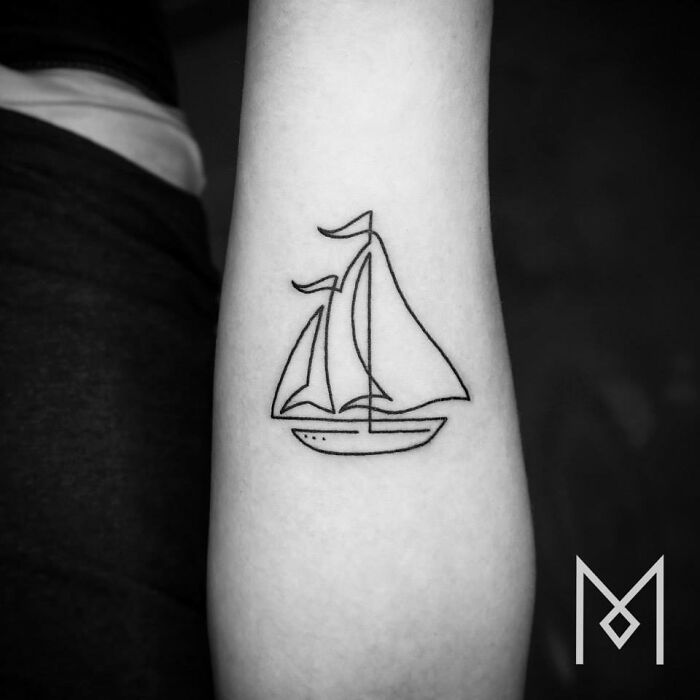 Single line tattoo of a sailboat on an arm, showcasing minimalist artistry.
