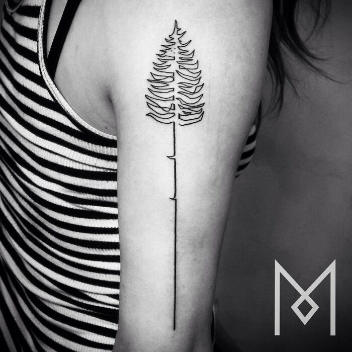 Single line tattoo of a tree on a person's arm, showcasing captivating minimalist design.