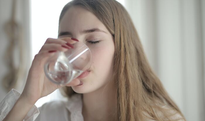 Woman Drinking Water From A Glass 