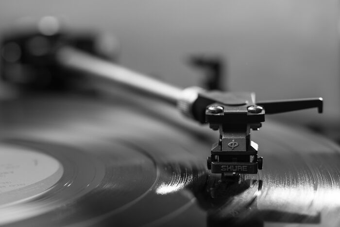 Close-up of a vinyl record playing on a turntable, showcasing one of the iconic old gadgets trendsetters.