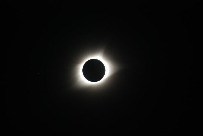 Total solar eclipse with corona visible against a dark sky, a breathtaking experience.