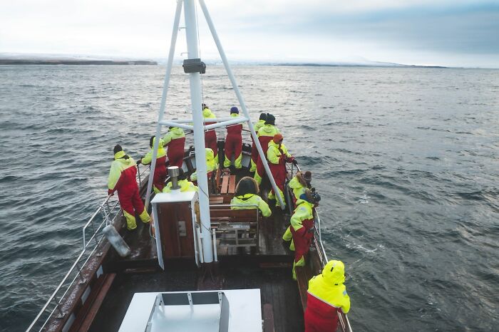People in bright jackets on a boat at sea, experiencing adventure and sightseeing, according to online suggestions.