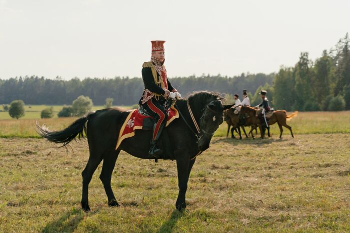 Man In A Costume Sitting On A Horse 