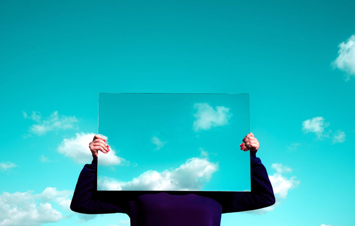 a person holding the picture of the sky on the sky background