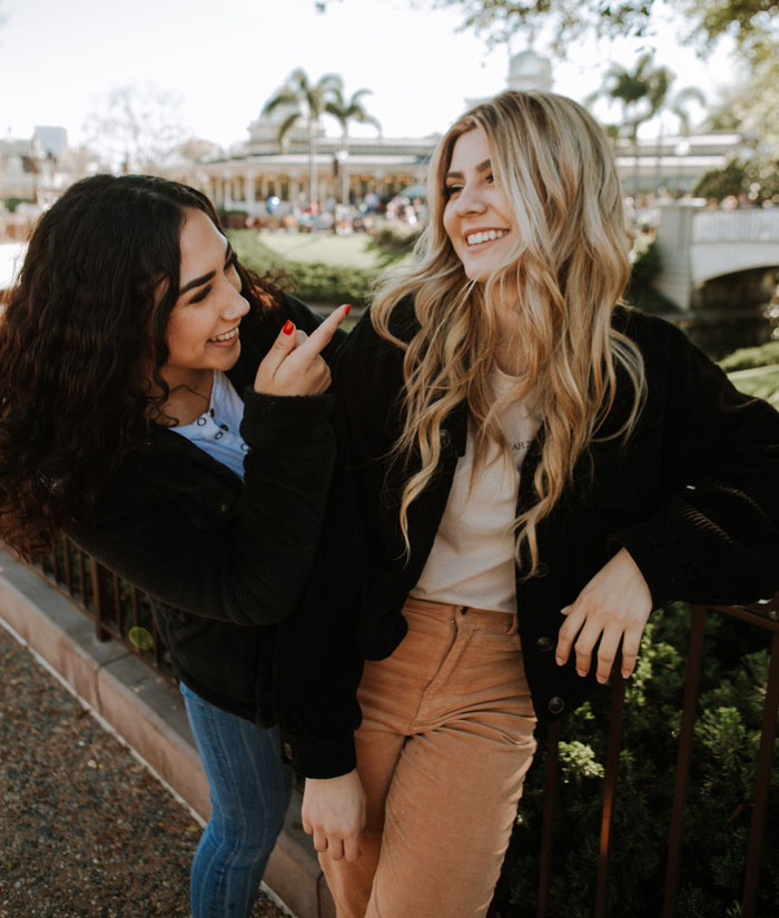 Friends wearing black jackets and laughing
