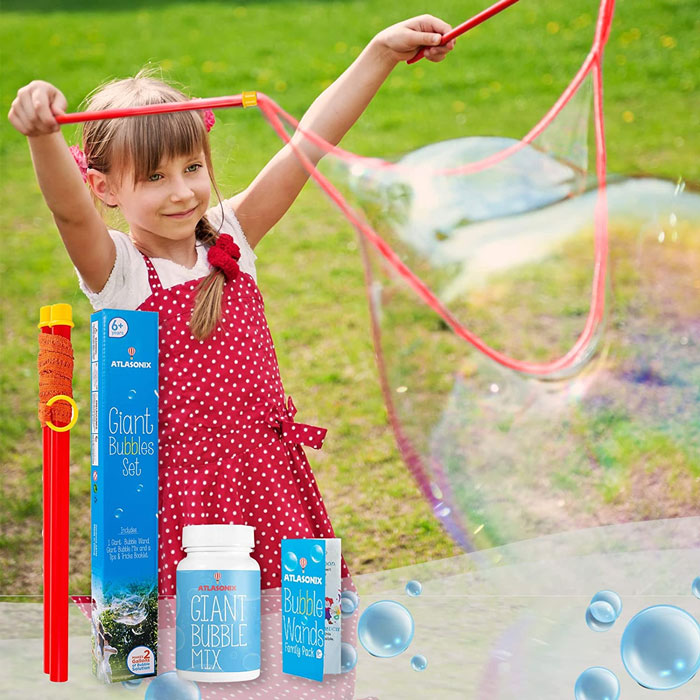 Girl making bubbles with bubble wand 