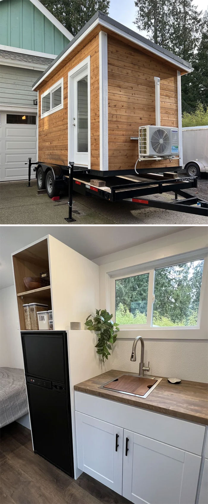 Tiny house design with wooden exterior on trailer and modern white kitchen cabinets inside under window.