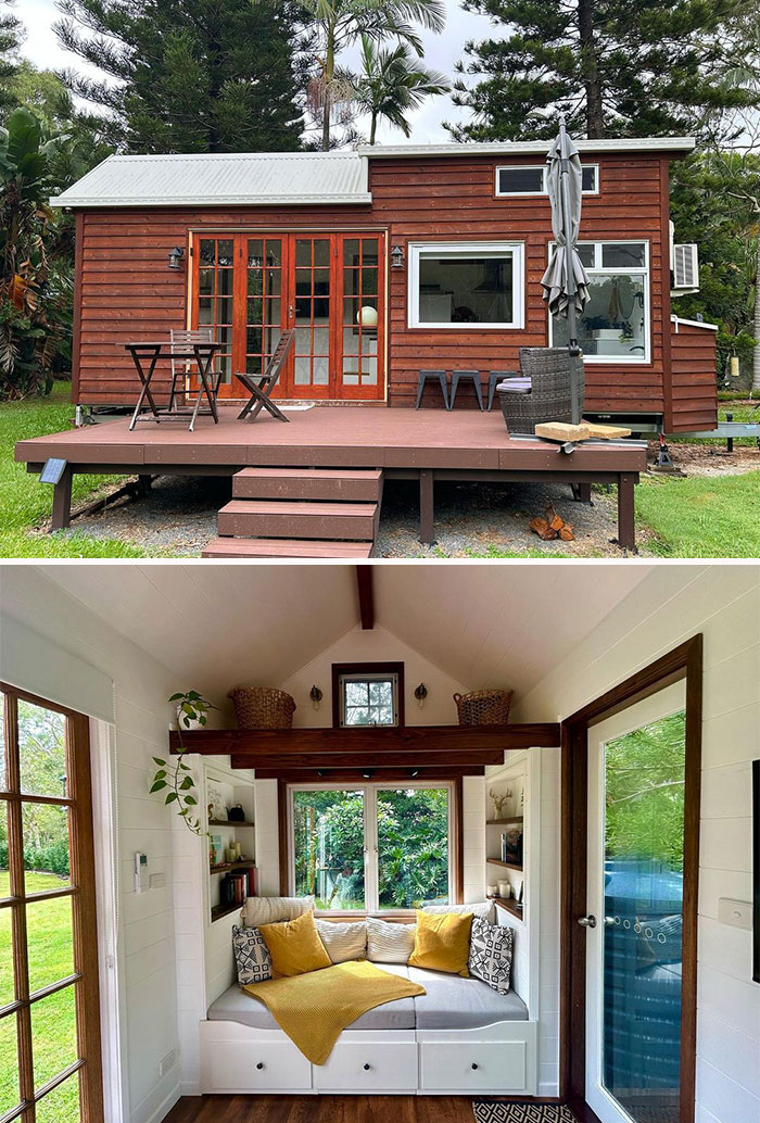 Red tiny house with spacious patio and outdoor seating surrounded by lush greenery, showcasing tiny house designs inspiration.