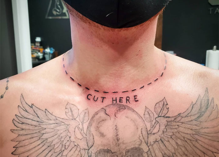 Tattoo design with "cut here" text above a detailed winged skull, considered lacking creativity.