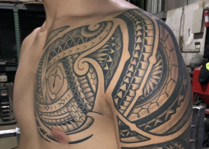 Tattoo design on a man's shoulder featuring intricate geometric patterns, often seen as lacking creativity.