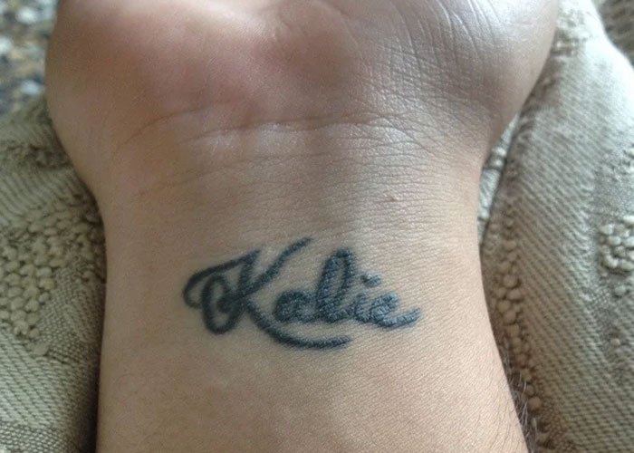 Wrist tattoo with the name "Kalie," showcasing a common design criticized for lacking creativity.