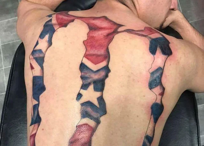 Tattoo design on a person's back depicting torn skin revealing stars and stripes, considered lacking creativity by some online.