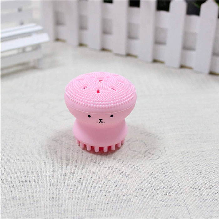 a pink silicone face brush in a form of jellyfish