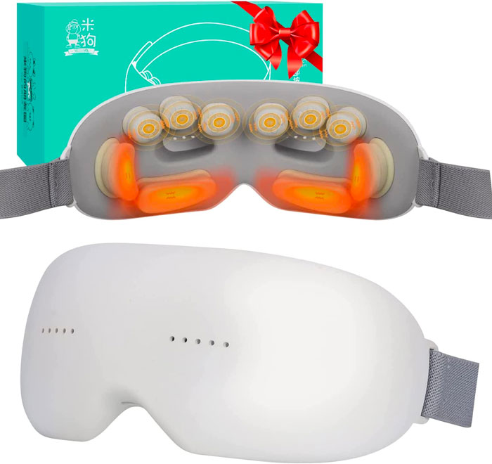 heating eye massager on the background of a present box