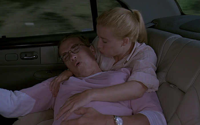 Woman blowing into Arnold Schwarzenegger face in the car 