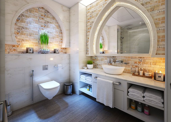 Modern bathroom with a unique arched mirror and decorative brick wall, illustrating weirdest guest house rules concept.