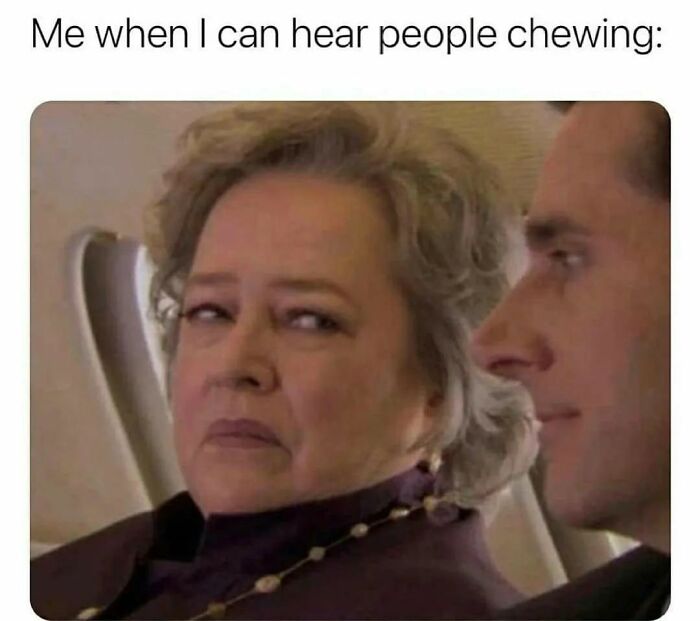 Older woman giving a side-eye glare while sitting next to a man, representing a relatable introvert meme about hearing people chewing.