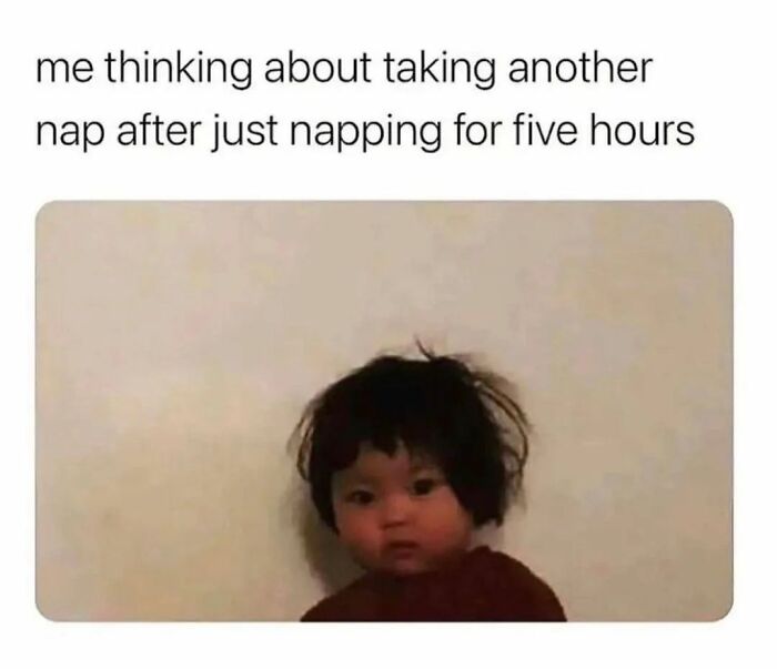 Child with messy hair looking tired, caption about thinking of taking another nap after already napping for five hours, relatable introvert meme.