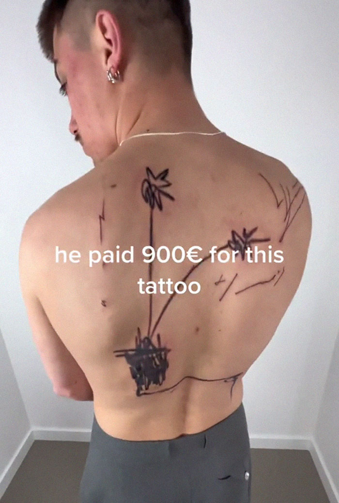 Tattoo artist's back piece on a man, with messy line work, causing online viral reaction.