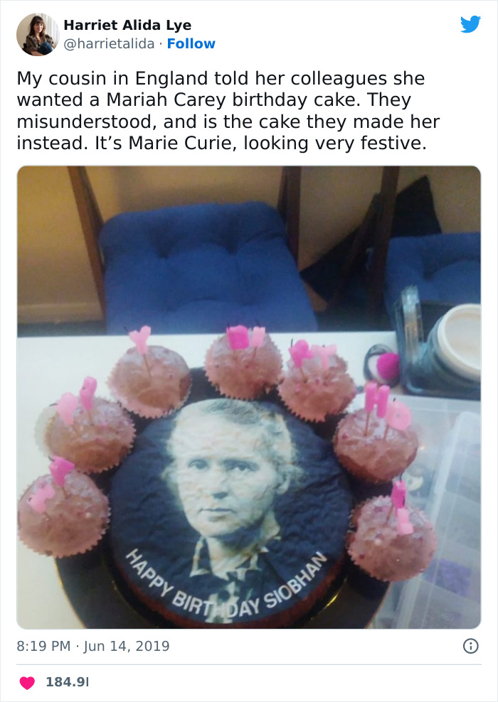 Marie Curie birthday cake surrounded by cupcakes with pink decorations featured in science memes collection.