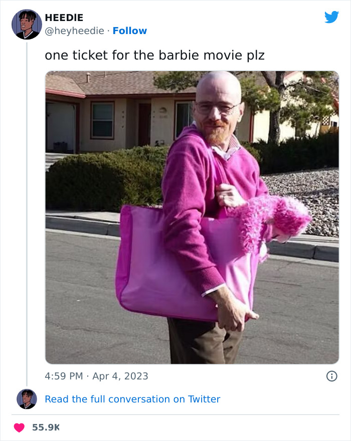 Man in a pink sweater and bag humorously preparing for the Barbie movie.