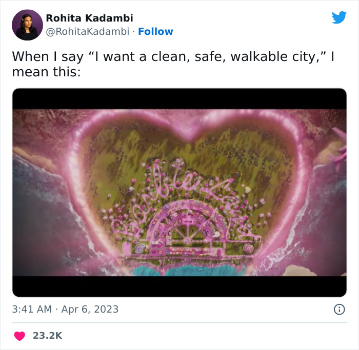 Aerial view of Barbie-themed island with "Barbie Land" written in vibrant pink tones, featuring a heart-shaped design.