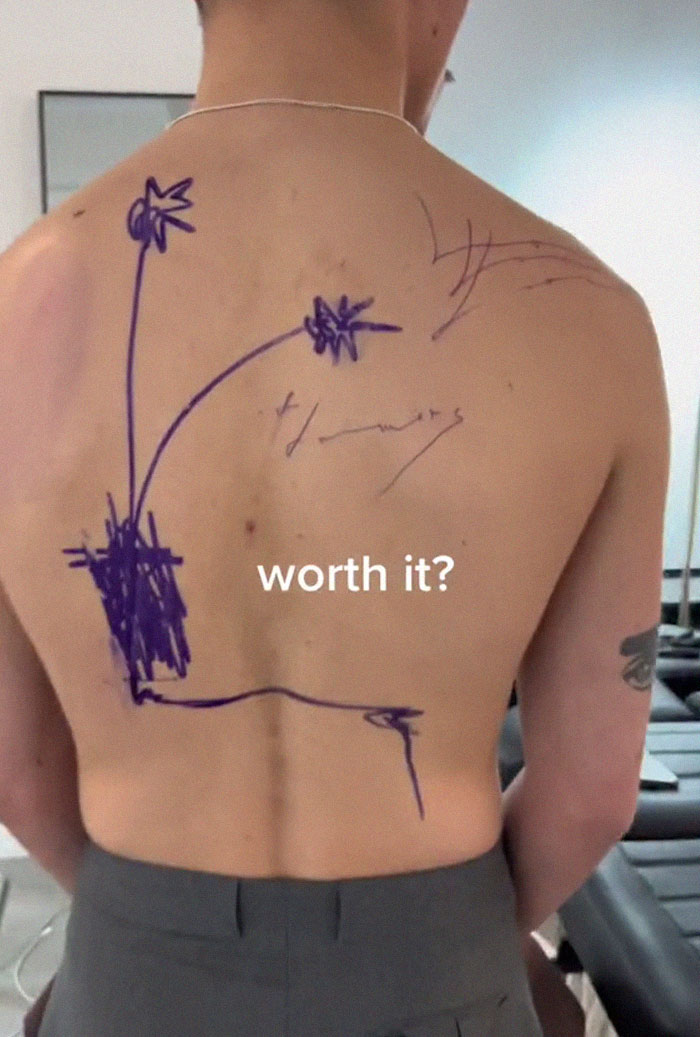 Tattoo artist's latest back piece drawing, sparking viral discussion and debate.