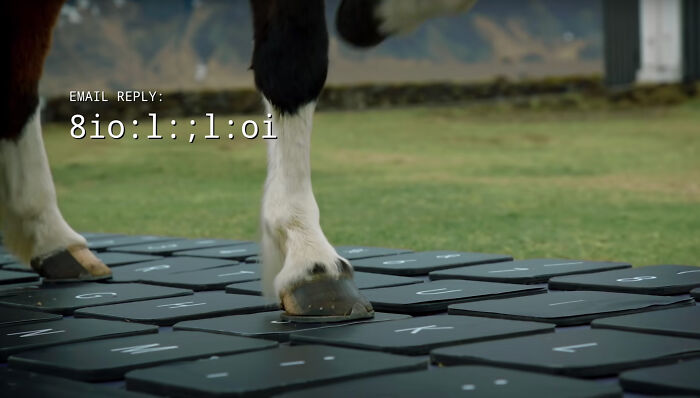Icelandic horse stepping on giant keyboard to reply to emails.