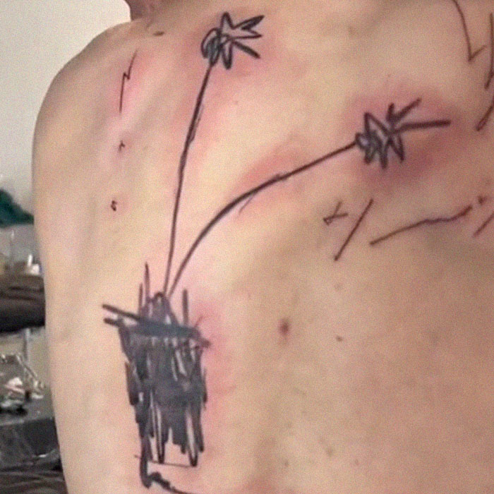 Tattoo on back with abstract lines, created by artist who went viral on social media.