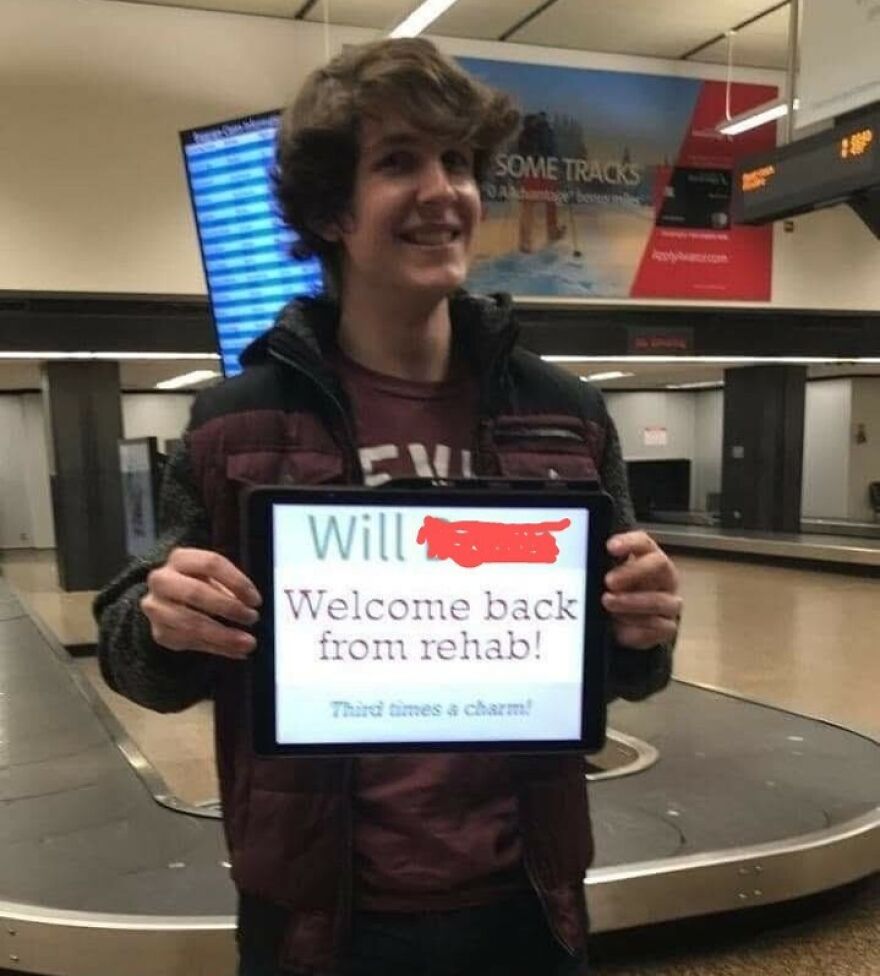 Man holding a tablet with a funny welcoming sign 