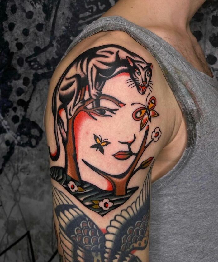 Optical illusion tattoo design featuring a panther and face with butterflies on a person's arm.