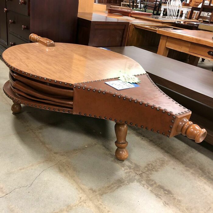A coffee table made from a gigantic fireplace bellows
