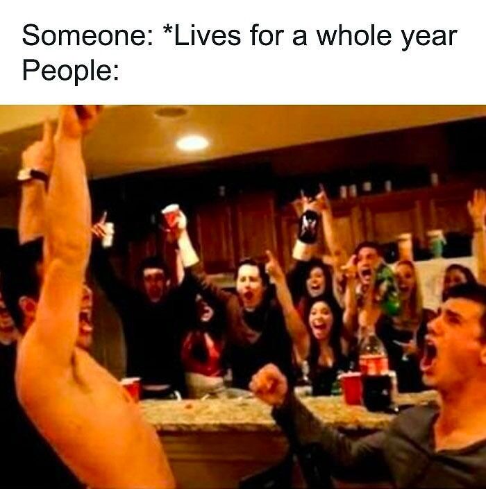 People cheering in a kitchen holding drinks, celebrating with funny happy birthday meme theme.