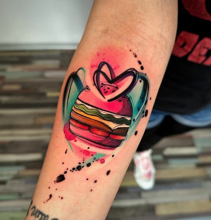 Watercolor tattoo of a burger with a heart, showcasing creative food ink-spiration.