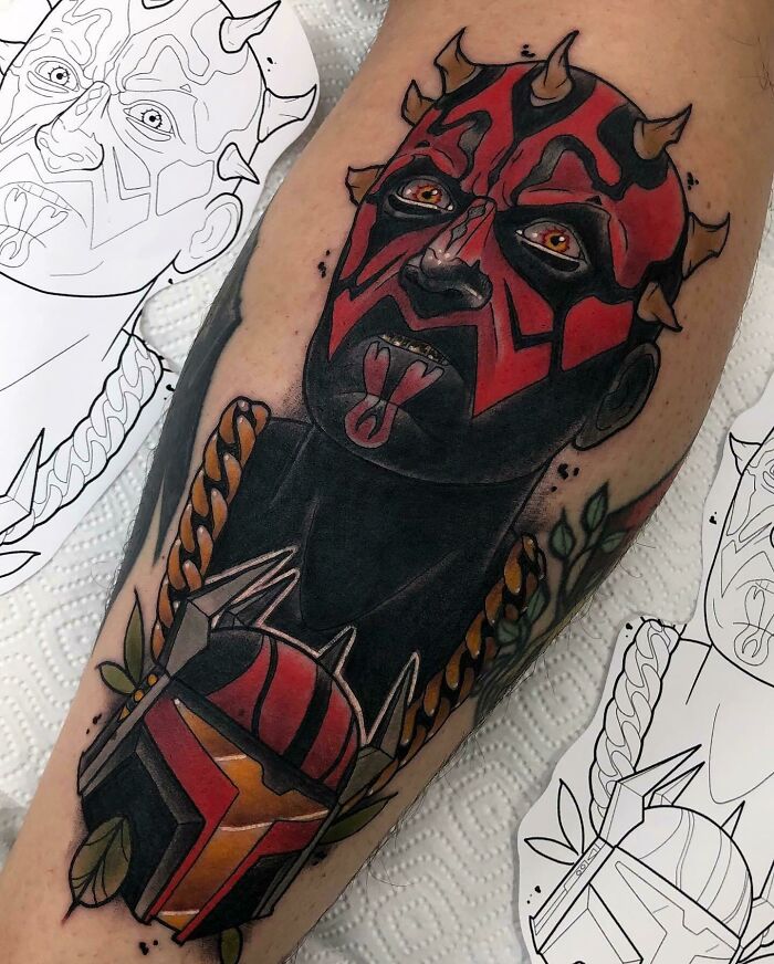 Pop culture tattoo of a horned character in red and black, with detailed design and vibrant colors on the forearm.
