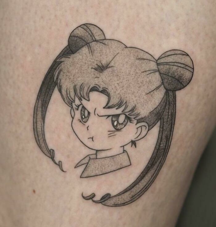 Pop culture tattoo of an anime character with pigtails expressing a playful pout.
