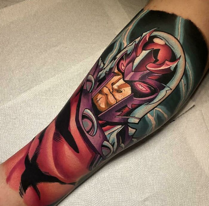 Colorful pop culture tattoo of a comic character covering a forearm.