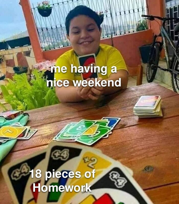 Child enjoying a weekend playing cards while facing a pile of homework in a humorous meme.