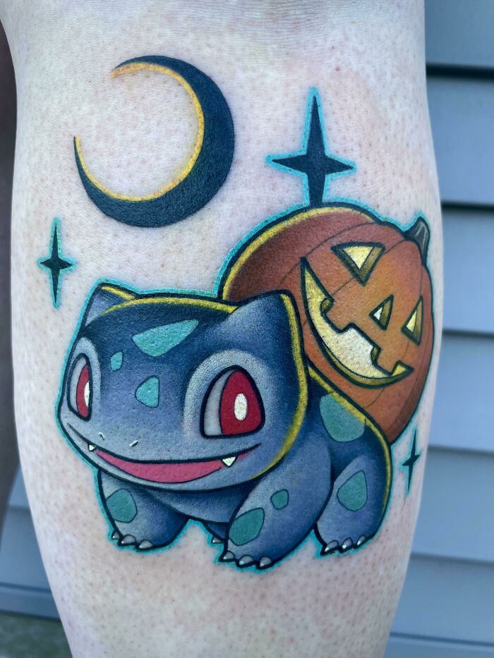 Pop culture tattoo featuring a cartoon creature with a pumpkin and crescent moon.