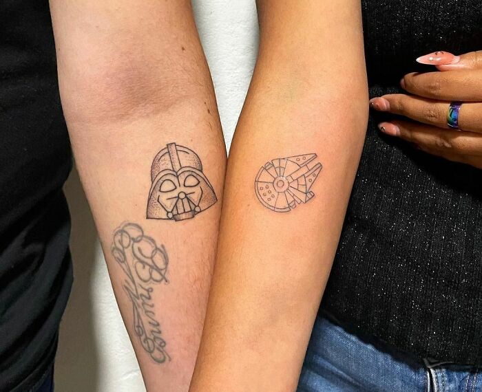 Matching tattoos for couples featuring Darth Vader and Millennium Falcon designs on forearms.