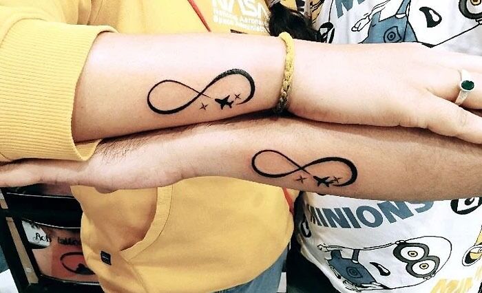 Matching infinity tattoos on arms, symbolizing bonds between special people in your life.