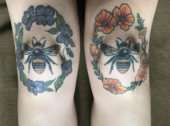 Bee knee tattoos surrounded by vibrant floral designs.