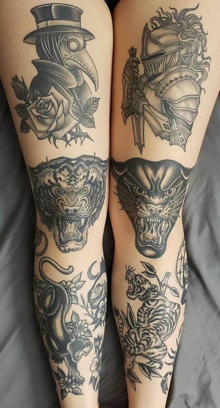 Knee tattoos featuring a knight and a plague doctor, alongside fierce animal designs on legs.