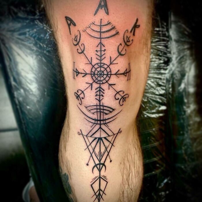 Geometric knee tattoo design, featuring intricate black ink patterns.