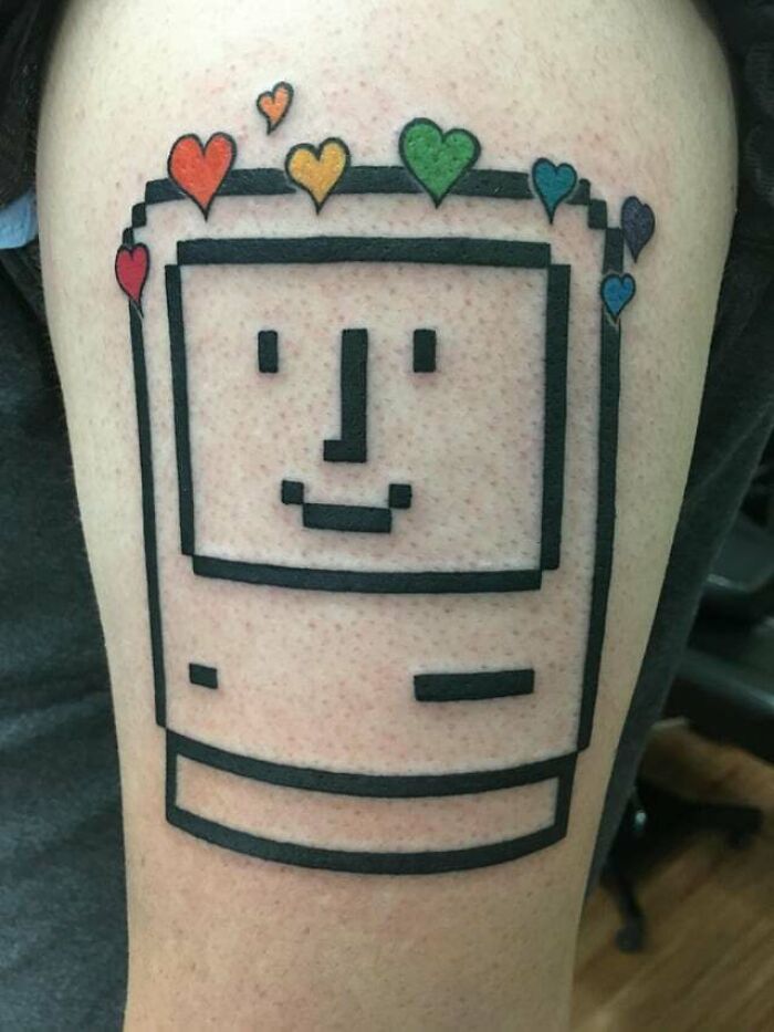 ‘90s culture tattoo of retro computer with colorful heart designs.
