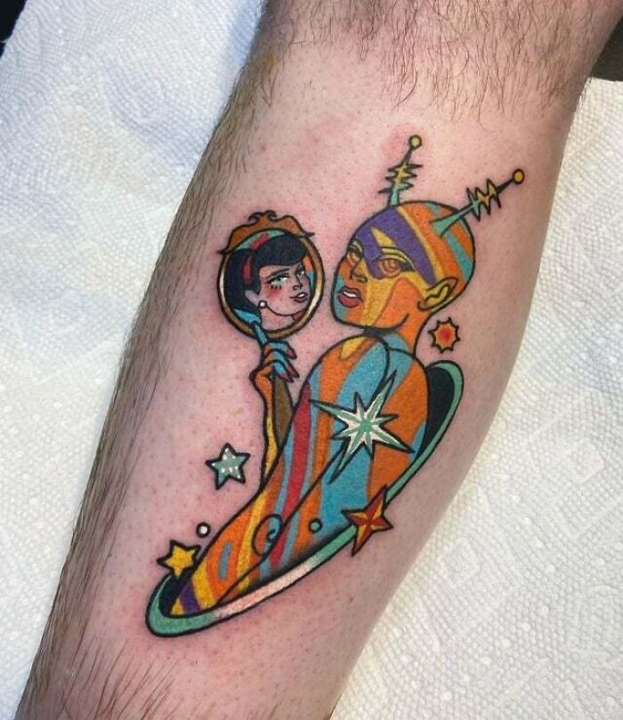 Colorful '90s tattoo with abstract cosmic design and human figures.