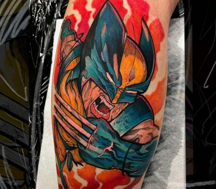 Colorful 90s tattoo of a comic book character in an action pose, featuring vibrant red and blue tones.