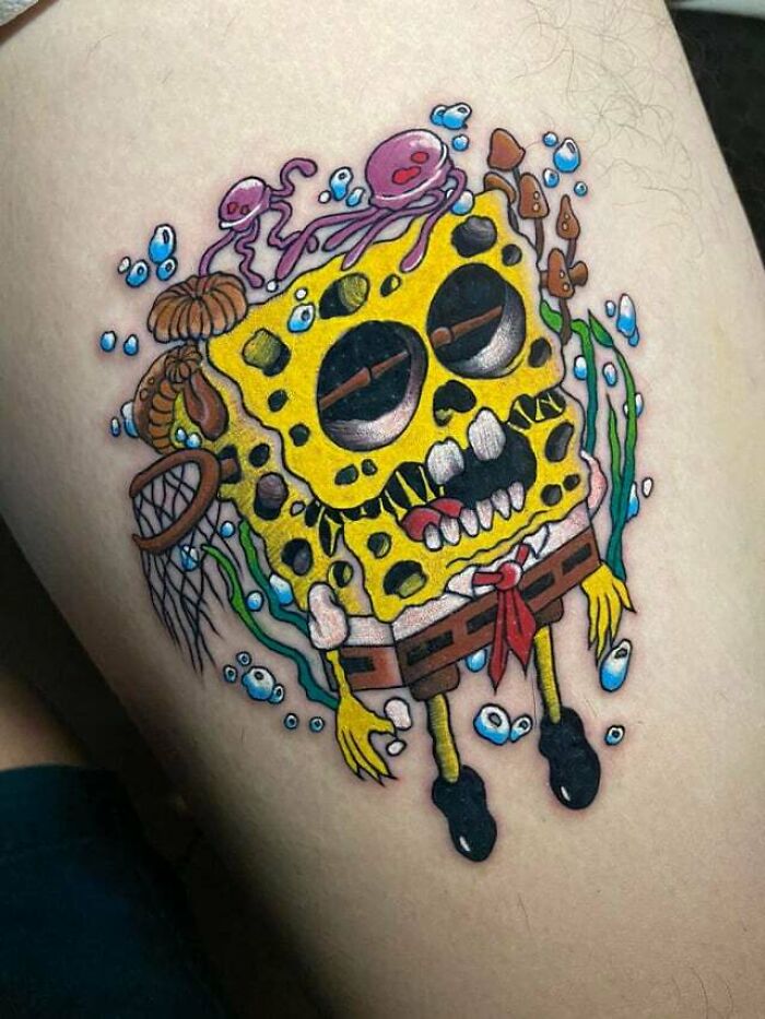 Colorful SpongeBob tattoo with ‘90s cultural flair, featuring sea life elements and bold shading.