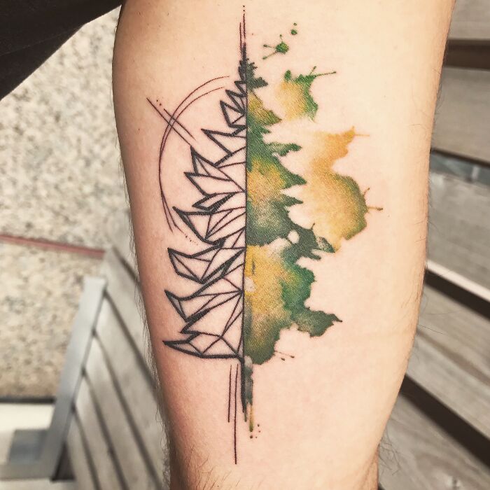 Abstract tree tattoo with geometric patterns and watercolor splashes on forearm, showcasing the wonders of nature.