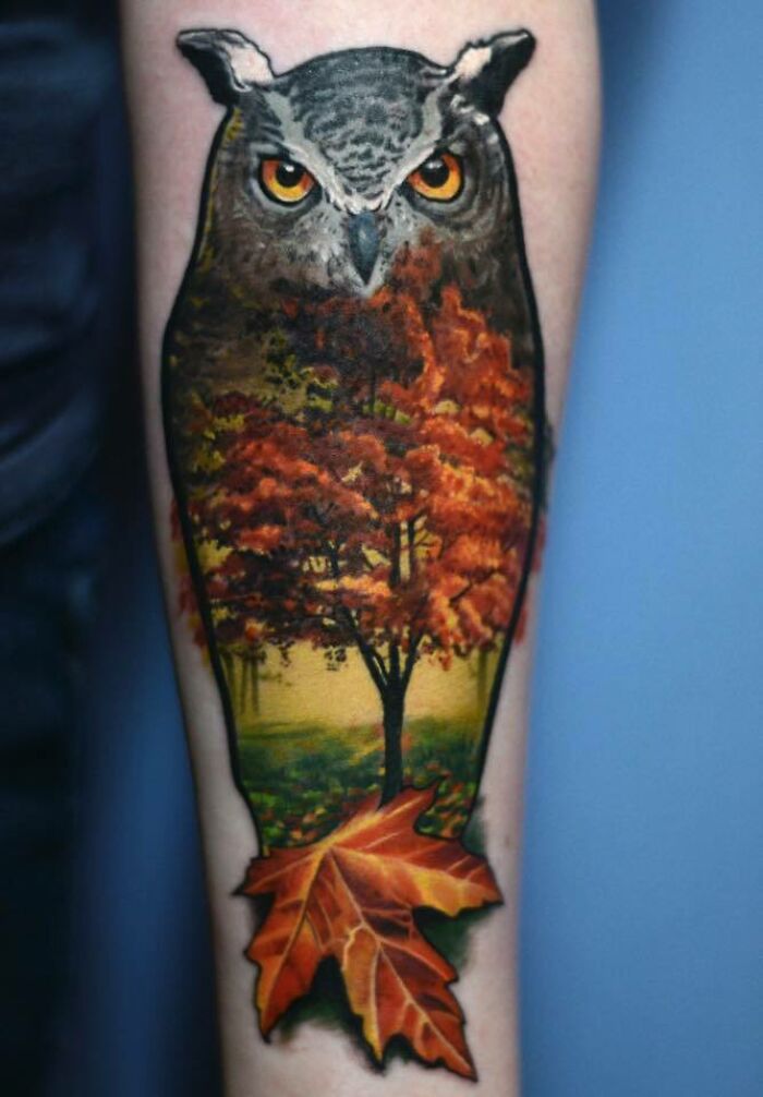 Majestic tree tattoo with an owl and autumn leaves blending seamlessly into the design.